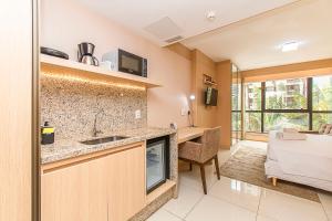 a kitchen with a sink and a table in a room at BSB STAY Flats Particulares - Cullinan SHN in Brasilia