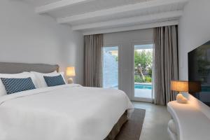 A bed or beds in a room at Patmos Aktis, a Luxury Collection Resort & Spa, Greece