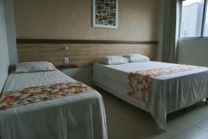 Postel nebo postele na pokoji v ubytování Moura Palace Hotel