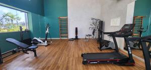 a gym with several exercise equipment in a room at Malia Beach Experience - Studios em Muro Alto por Yolo in Ipojuca