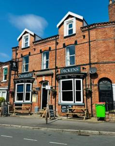 a brick building with a sign in front of it at The Charles Dickens Hotel in Wigan +13 photos