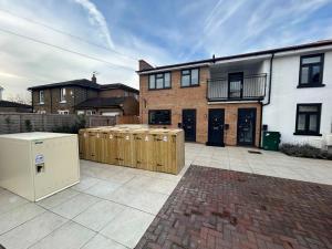 a backyard of a house with a refrigerator at London Mitcham Beautiful Three Bedroom House in Mitcham