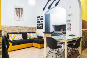 a living room with a couch and a table at "La casa di Ryan" - Intera casa - Policlinico - Cittadella - Tra Cagliari e il mare in Monserrato