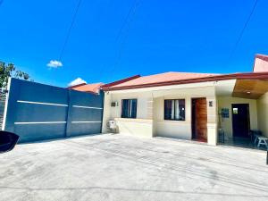 a house with a fence and a driveway at MC2 Homestay Butuan in Butuan