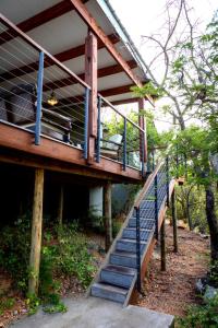a house with a staircase leading up to it at Ndlovu Bushvilla at Elephant Rock Eco Estate in Mica