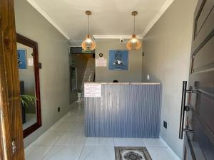 a hallway with a counter in a room with lights at Adiel Guesthouse in Cape Town +16 photos