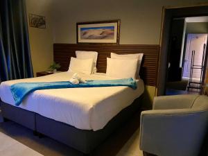 a bedroom with a bed with a stuffed animal on it at Adiel Guesthouse in Cape Town