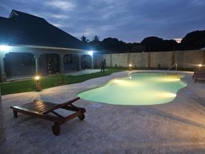 a swimming pool in a yard at night at Ferienhaus Vacation Villa Diani Beach in Kinondo