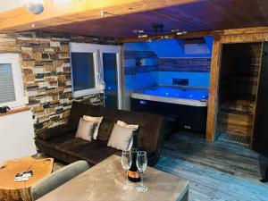 a living room with a couch and a tub at Apartment Mastnak - Private Wellness & Jacuzzi in Laško