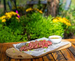 a plate of meat and a bowl of sauce on a table at Boutique Hotel Karel de Stoute in Gorinchem +35 photos