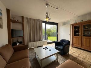 a living room with a couch and a table at Heggerank 54 in Nieuwvliet