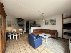 a living room with a couch and a table at Heggerank 54 in Nieuwvliet
