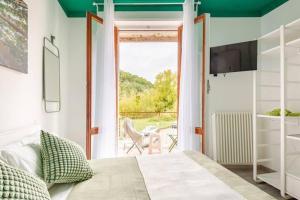 a bedroom with a bed and a sliding glass door at Boutique Apartment Natura in Chiusi