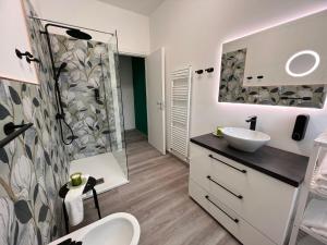 a bathroom with a sink and a shower at Boutique Apartment Natura in Chiusi +14 photos