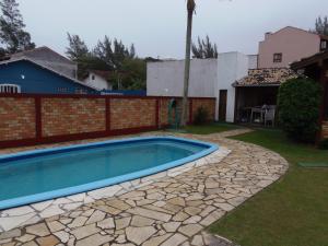 a swimming pool in the yard of a house at Pousada da Villa in Imbituba