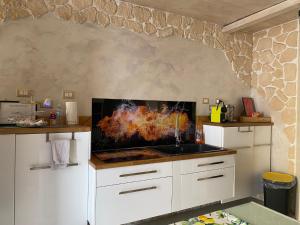 a kitchen with a stove with a fire in it at Fantasy House in Cremona