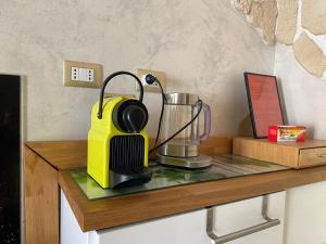 a yellow blender sitting on a counter with a table at Fantasy House in Cremona