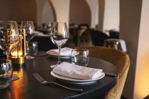 a table with wine glasses and napkins on a table at The Donna Portals in Portals Nous