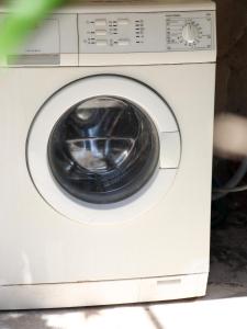 a white washing machine with its door open at Willy Apartments in Velipojë
