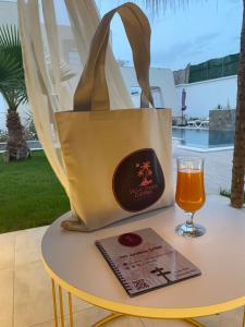 a bag sitting on a table with a glass of beer at Villa oasis in Houmt Souk