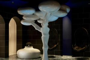 a white sculpture of a plant on a table at The Donna Portals in Portals Nous +127 photos