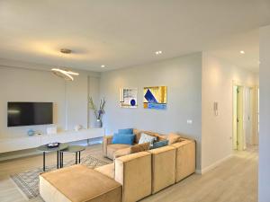 a living room with a couch and a tv at Sunset Paradise - 294 in Durrës