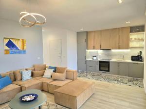 a living room with a couch and a kitchen at Sunset Paradise - 294 in Durrës