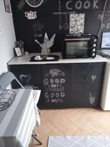 a room with a dresser with a black wall at Comfy Studio in Lamía +10 photos