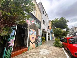 a mural of a woman with glasses on a building at Memorial Hotel in São Paulo