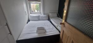 a small room with two beds and a window at Extended 3BD SplitLevel Cottage in Popular Village in Dublin +8 photos