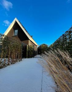 a house with a snow covered sidewalk in front of it at ' Zilten Huus Zoutelande in Zoutelande