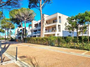 an apartment building with a tennis court in front at Wide Beach Apartment - 289 in Mullini i Danit