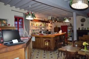 a bar in a restaurant with a computer on a counter at Le Relais du Morvan in Vézelay