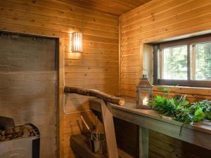 a wooden cabin with a window and a wooden counter at Holiday Home Rinnekämppä by Interhome in Pätiälä +2 photos