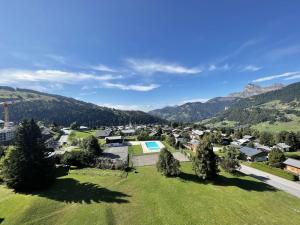an aerial view of a small town in the mountains at Studio cosy au pied des pistes avec piscine et parking - 4 pers - FR-1-595-19 in Notre-Dame-de-Bellecombe
