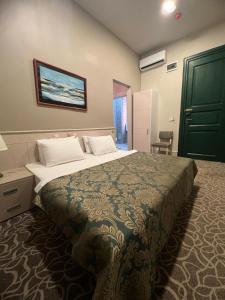 a bedroom with a large bed with a green door at Aria Palace Taksim in Istanbul