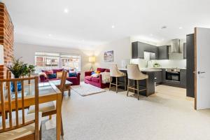 a living room with a couch and a table at Osbourne House - BLUE 2 Bedroom,2 and half bath in Birmingham