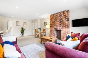 a living room with two couches and a fireplace at Osbourne House - BLUE 2 Bedroom,2 and half bath in Birmingham