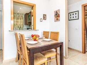 a dining room with a wooden table and chairs at Apartment La Mar Bella by Interhome in El Borseral