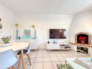 a living room with a table and a fireplace at Holiday Home Green House by Interhome in Empuriabrava