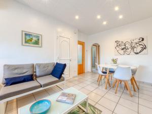 a living room with a couch and a table at Holiday Home Green House by Interhome in Empuriabrava +23 photos