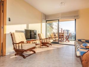 a living room with chairs and a tv and a couch at Apartment Las Terrazas- La Marina-1 by Interhome in Oropesa del Mar