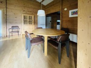 a wooden dining room table and chairs in a kitchen at Holiday Home De Brenkberg by Interhome in Schinveld