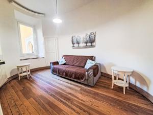 a living room with a couch and a table at Apartment Blu - Borgo Antico by Interhome in Porto Valtravaglia