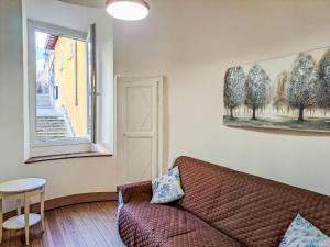 a living room with a couch and a window at Apartment Blu - Borgo Antico by Interhome in Porto Valtravaglia