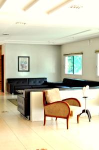 a living room with a pool table and chairs at Hotel Executivo in Araguaína