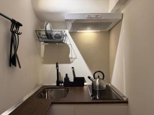 a kitchen sink with a tea kettle on a counter at La Casupola by MONHOLIDAY in Monopoli +5 photos