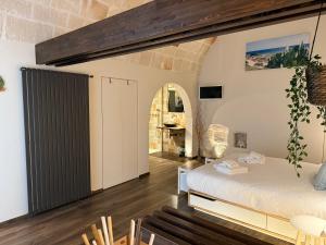a bedroom with a bed and a table and chairs at La Casupola by MONHOLIDAY in Monopoli