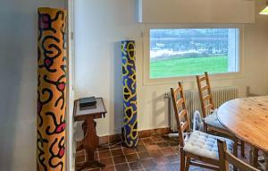 a dining room with a table and a window at Awesome Home In Saint Pabu With Sauna in Saint-Pabu