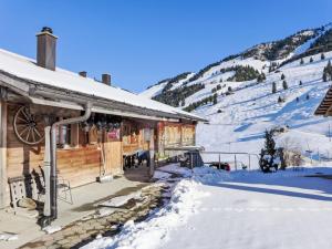 a log cabin in the snow with a mountain at Apartment Bühl by Interhome in Achseten